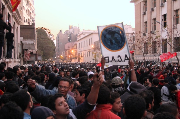 Protesters carry a sign that says, “All Cops Are Bastards,” a play on the Interior Ministry’s slogan, on Feb. 2nd, 2012.  An other protester holds a sign that says, "Where were the police during the soccer match?  They didn’t secure it, so they were involved in what happened there." (Photo by  Hamada Elrasam)